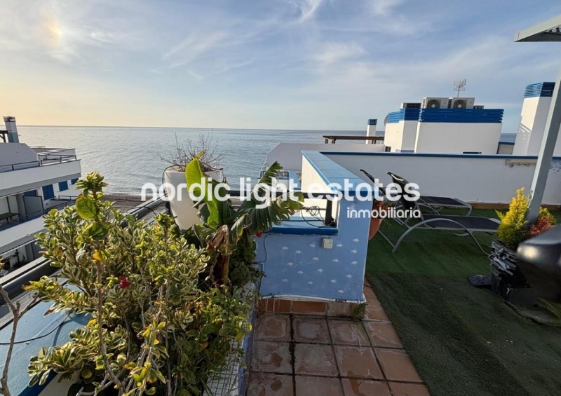 Beachfront living at its finest with this stunning penthouse duplex in Torrox Costa 